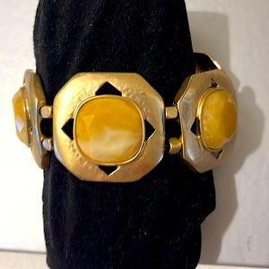 Gold tone stretch bracelet with light yellow resin centers